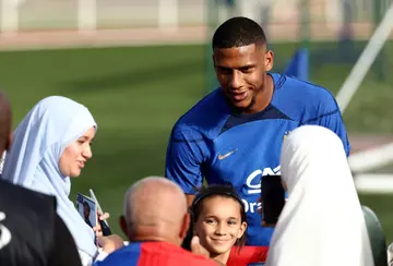 France defender Jean Clair Todibo (C) signs autographs before a training session ahead of Euro 2024 qualifiers