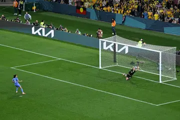 Mackenzie Arnold saves a penalty from France's Kenza Dali during the shootout