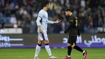 Lionel Messi walks past Cristiano Ronaldo during the Winter Tour 2023 friendly between Paris Saint-Germain and Riyadh XI at King Fahd International Stadium. Photo by Yasser Bakhsh.