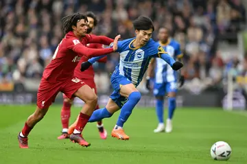 Brighton winger Kaoru Mitoma tries to get away from Liverpool's Trent Alexander-Arnold