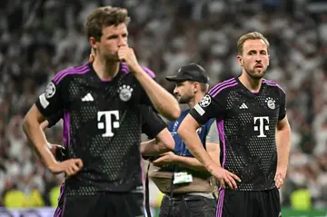 Bayern Munich forwards Thomas Mueller (L) and Harry Kane after their 2-1 loss to Real Madrid