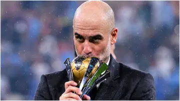 Pep Guardiola poses for photos with the winners' trophy during the FIFA Club World Cup Final match between Manchester City and Fluminense at King Abdullah Sports City. Photo by Marcio Machado.