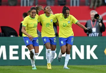 Brazil's midfielder Kerolin celebrates scoring with her teammates Gabi Nunes (L) and Ary. Brazil beat Germany 2-1 in Nuremberg.