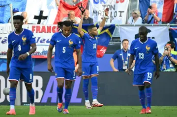 Kylian Mbappe removed his mask to celebrate scoring a penalty to put France ahead but they were frustrated by Poland