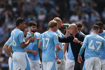 Manchester City manager Pep Guardiola gives instructions to his title-chasing players