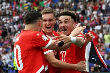 Switzerland's midfielder  Ruben Vargas (R) celebrates with teammates after scoring his team's second goal against Italy