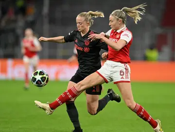 Bayern's match-winner Lea Schueller (L) scraps with Arsenal's Leah Williamson during Tuesday's Women's Champions League quarter-final first leg between the sides
