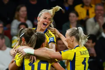 Sweden players celebrate scoring their second goal