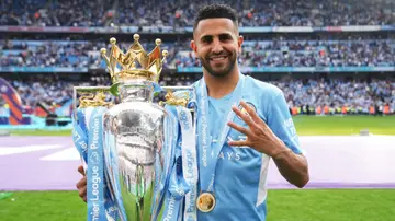 Riyad Mahrez celebrates with the Premier League trophy during the Premier League match between Manchester City and Aston Villa at Etihad Stadium. Photo by Matt McNulty.