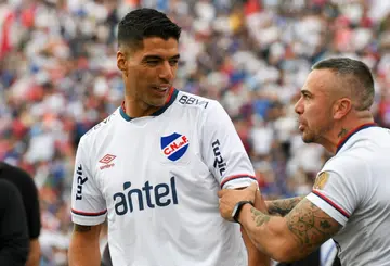 Uruguayan star forward Luis Suarez (left) is greeted by a fan at his official presentation as a Nacional player