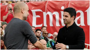 Pep Guardiola interacts with Mikel Arteta prior to the Premier League match between Arsenal FC and Manchester City at Emirates Stadium. Photo by David Price.