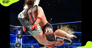 AJ Styles (r) takes down Dolph Ziggler (l).