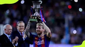 Former Barcelona's forward Lionel Messi celebrates holding the Super Cup in 2016