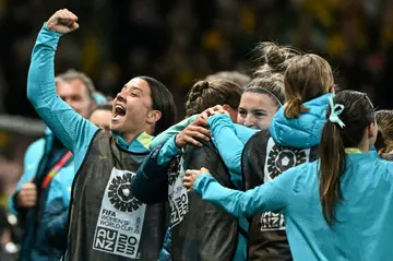 Australia forward Sam Kerr (L) was animated on the bench against Canada