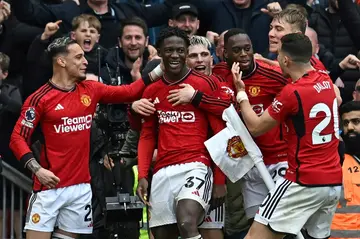 On target: Kobbie Mainoo (C) celebrates with teammates after scoring Manchester United's second goal during a 2-2 draw at home to Liverpool in the Premier League