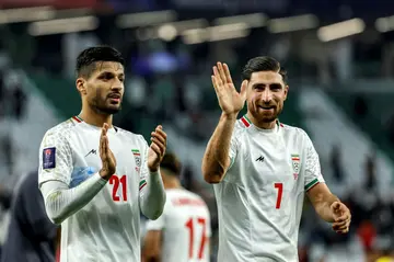 Iran's Mohammad Mohebi and (R) Alireza Jahanbakhsh celebrate in the group phase