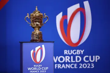 The William Webb Ellis Trophy and the 2023 Rugby World Cup logo.