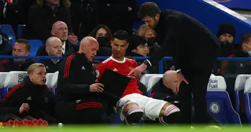 Cristiano Ronaldo takes instructions from Michael Carrick as he prepares to come on as a substitute during the Premier League match between Chelsea and Manchester United at Stamford Bridge (Photo by Clive Rose/Getty Images)