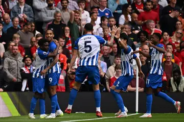 Brighton celebrate during their victory at Manchester United