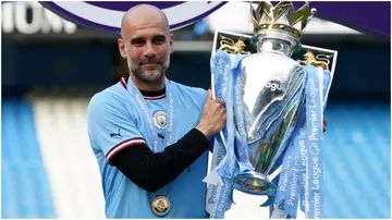 Pep Guardiola poses with the Premier League winner's trophy at the Etihad Stadium. Photo by Martin Rickett.
