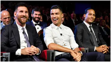 Cristiano Ronaldo and Lionel Messi react during the UEFA Champions League draw at Salle des Princes. Photo by Harold Cunningham.