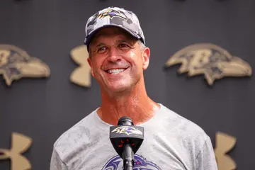 How much does John Harbaugh make on average?