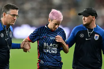 Megan Rapinoe is helped off the pitch after an injury minutes into her OL Reign's NWSL final clash with Gotham FC, the final game of Rapinoe's storied career