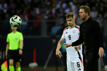 Germany's head coach Julian Nagelsmann (r), flanked by  veteran defender Joshua Kimmich, gives directions against Ukraine