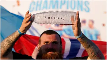 A Man City fan mocks the Gunners with a bottle written 'Arsenal' on it outside of the Etihad Stadium Photo: PA.