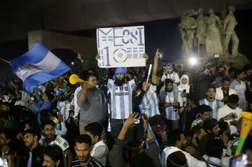 Argentinian supporters react as they watch the final football match of the Qatar 2022 World Cup between Argentina and France in Dhaka, Bangladesh on December 18, 2022