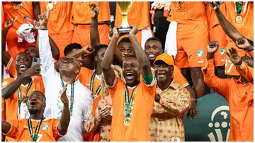 Max-Alain Gradel lifts the Africa Cup of Nations trophy on the podium after Ivory Coast won the Africa Cup of Nations 2023. Photo: Franck Fife.