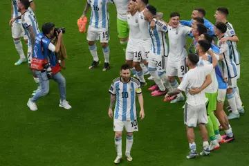 Lionel Messi celebrates with his teammates after leading Argentina into the World Cup final