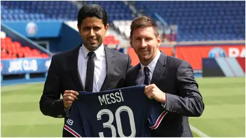 Lionel Messi poses with his jersey next to PSG President Nasser Al Khelaifi at Parc des Princes. Photo by Sebastien Muylaert.