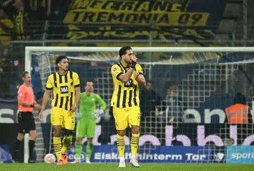 Dortmund midfielder Emre Can signals to the referee in his side's match away at Bochum on Friday