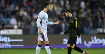 Lionel Messi walks past Cristiano Ronaldo during the Winter Tour 2023 friendly between Paris Saint-Germain and Riyadh XI at King Fahd International Stadium. Photo by Yasser Bakhsh.