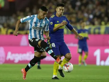 Racing Club midfielder Carlos Alcaraz (L) during a match against Boca Juniors in Lanus, Buenos Aires, on May 14, 2022