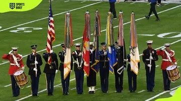 The United States Army Forces display the flags while playing the national anthem