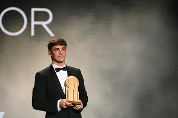 Gavi poses with the Kopa Trophy for the best player of last season aged under 21 at Monday's Ballon d'Or gala in Paris