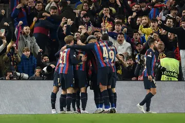 Barcelona's Brazilian forward Raphinha celebrates with teammates after scoring his team's second goal against Man United