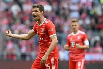 Bayern Munich captain and forward Thomas Mueller celebrates as his side beat Hertha Berlin 2-0 to return to the top of the table