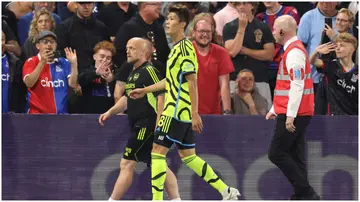 Takehiro Tomiyasu walks off the pitch after being sent off for a second yellow card during the Premier League match between Crystal Palace and Arsenal, Photo by Julian Finney.