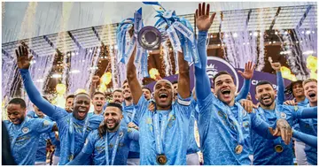 Fernandinho of Manchester City lifts the Premier League Trophy with teammates Benjamin Mendy, Riyad Mahrez, Ederson and Sergio Aguero. Photo by Michael Regan.