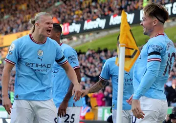 Manchester City's Jack Grealish (R) celebrates with Erling Haaland