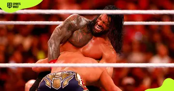 Roman Reigns (top) wrestles for the WWE Universal title.