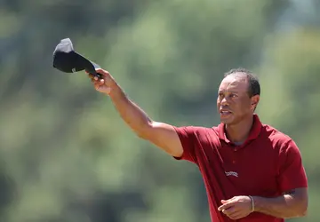 Tiger Woods of the United States waves his hat