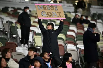 A young fan holds up a placard to cheer on Lionel Messi in Tokyo