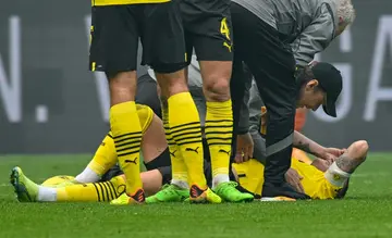 Dortmund's German forward Marco Reus lies on the pitch after sustaining injury against Schalke on September 17.