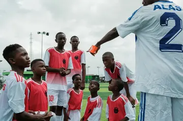 The coach for a local football team picks positions for his players