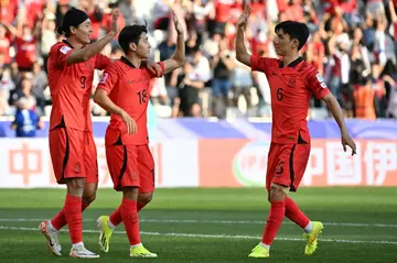 Lee Kang-in (18) celebrates with teammates after scoring his team's third