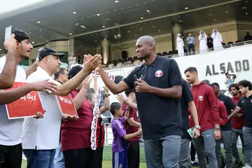 National pride: Qatar defender Abdelkarim Hassan greets fans